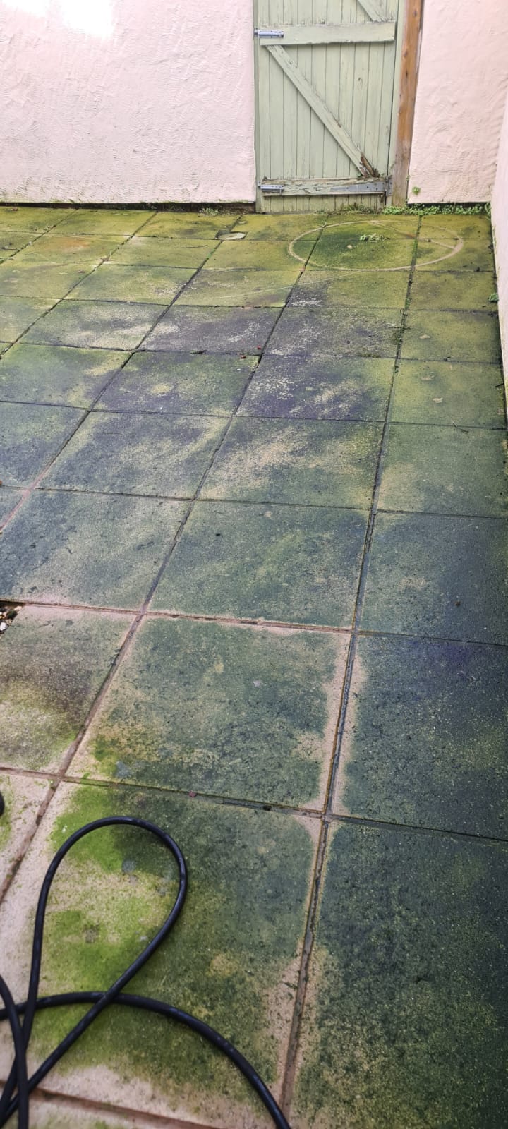 Grimy grey slab pathway before pressure washing in the Wirral