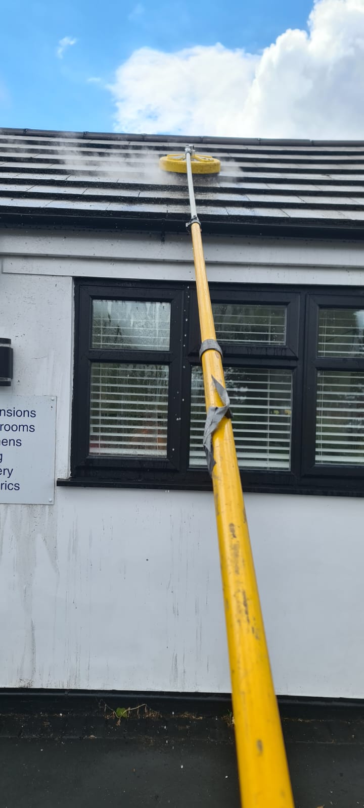 Window cleaning in the Wirral, water-fed pole cleaning upper windows and frames