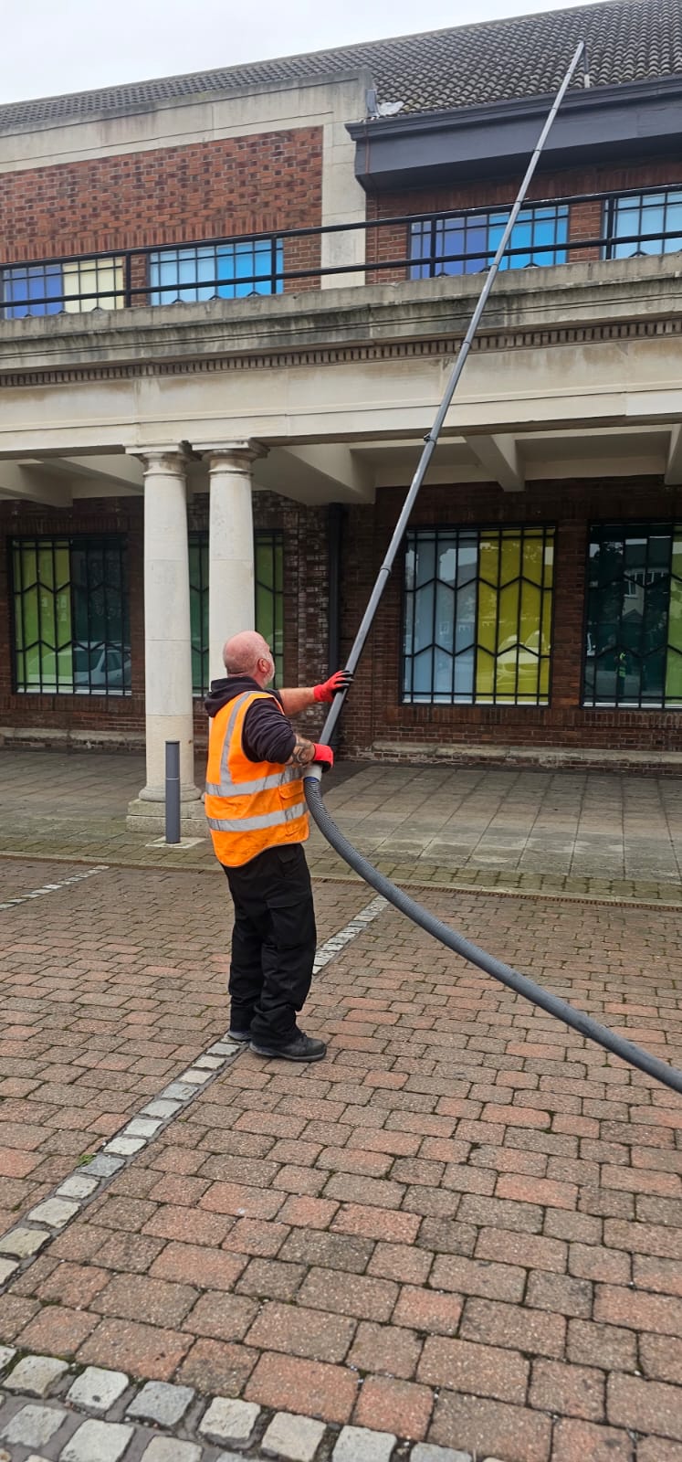 Gutter vacuum system clearing a large Wirral commercial roofline