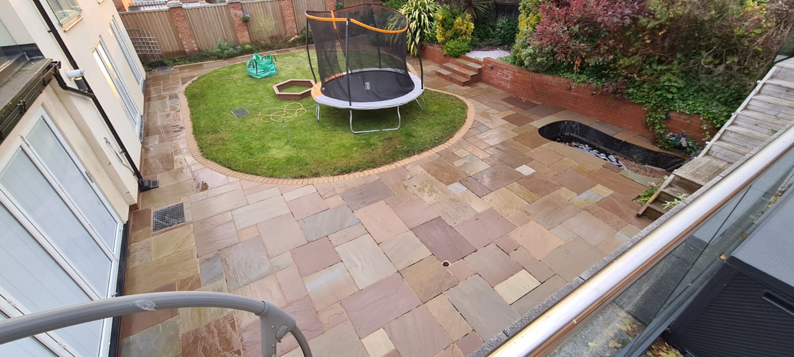 Driveway cleaning results beside a Wirral property boundary wall