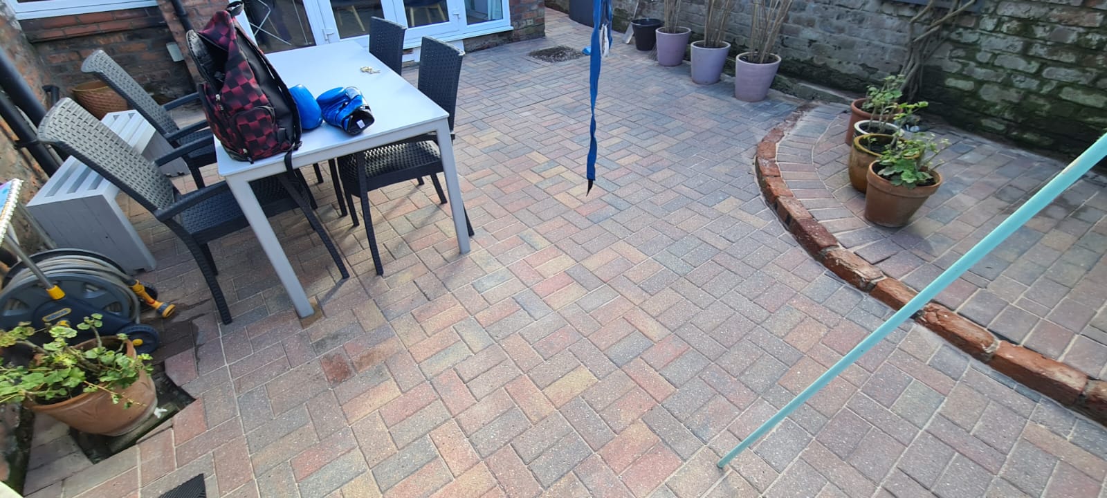 Cleaned multi-coloured stone patio in a Wirral garden