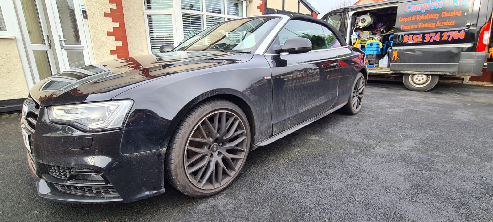 Black saloon car before an exterior valet in the Wirral