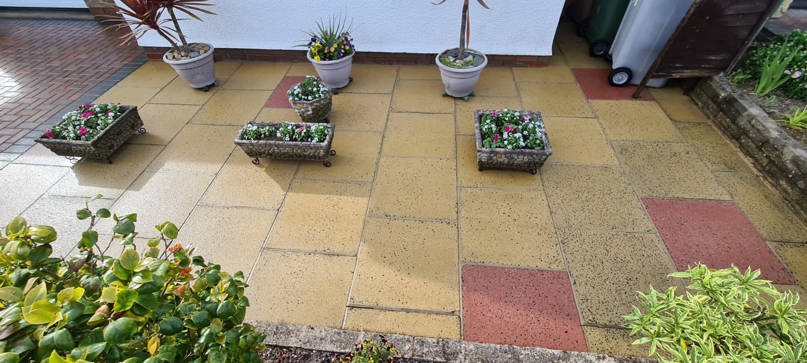 Patio slabs and planters cleaned by pressure washing in the Wirral