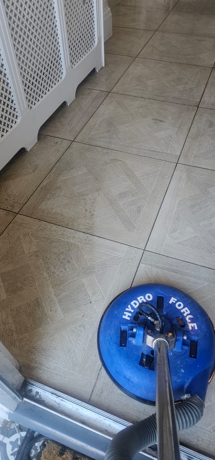 Floor scrubbing machine cleaning tiled flooring at a Wirral premises