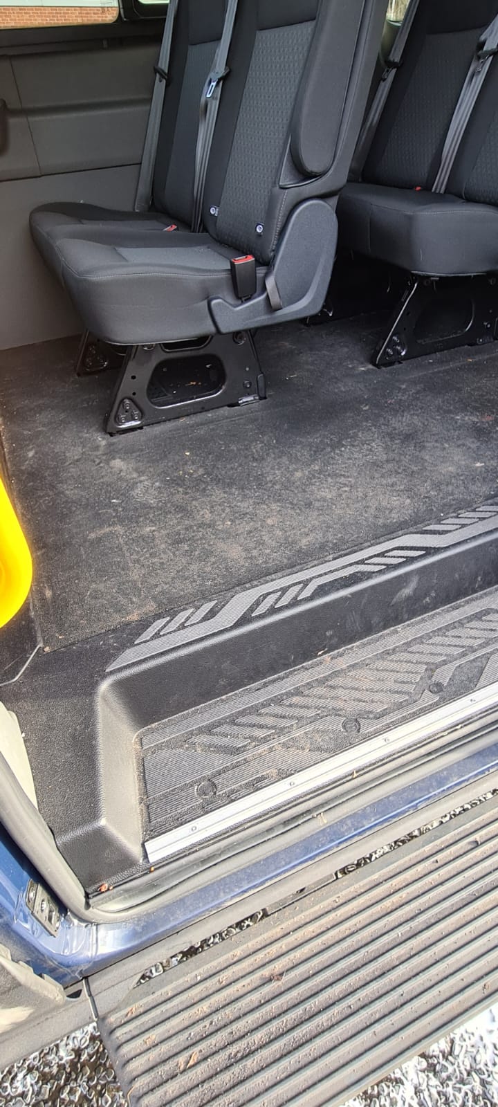 Minibus seats and step before an interior valet in the Wirral