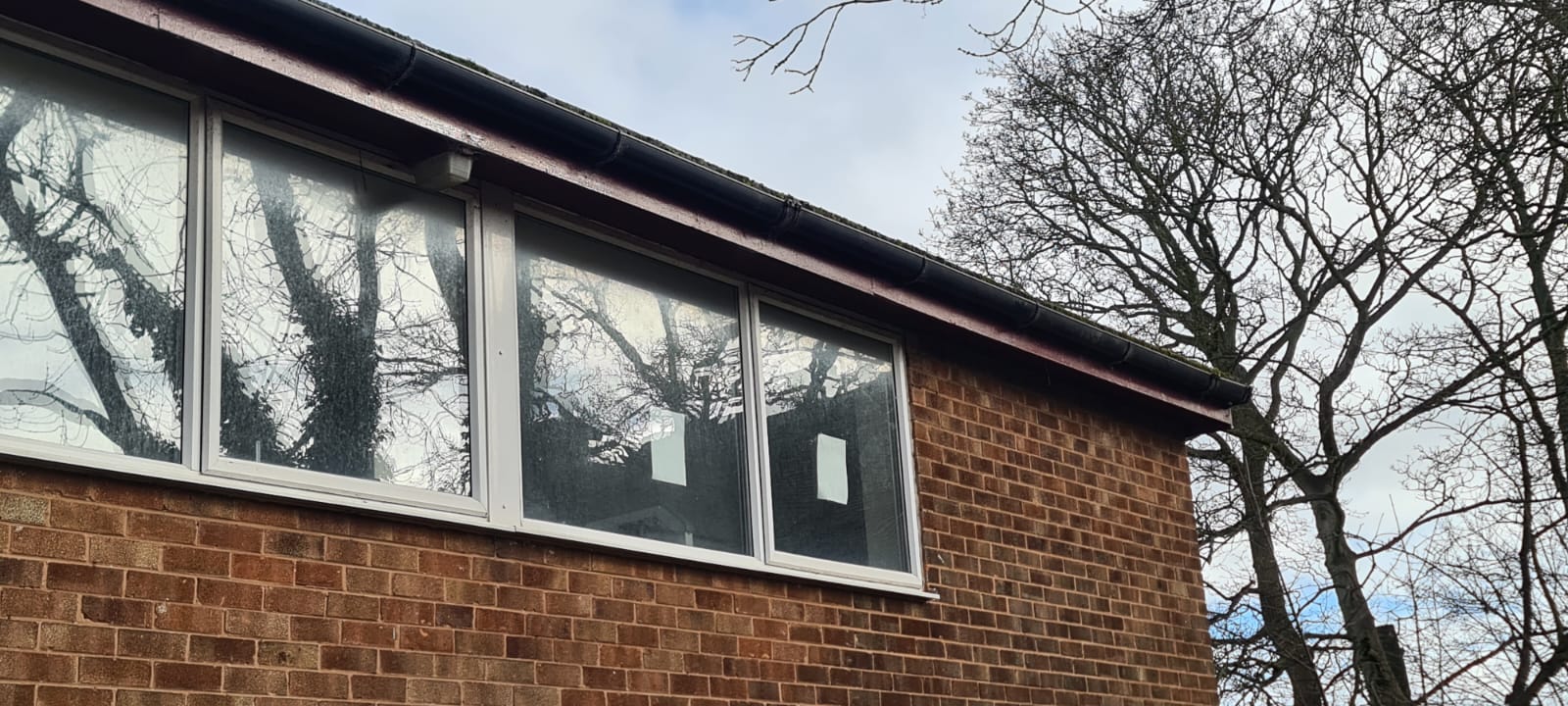 Cleared gutter and cleaned window frame after a Wirral gutter clearance